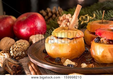 Baked Apples On Brown Plate With Holiday Christmas Decoration