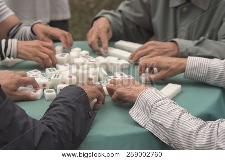 Mahjong Board Game. Playing Mahjong On Table. People Play A Board Game In The Park