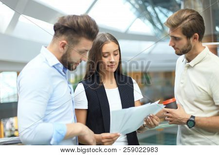Group Of Young Modern People In Smart Casual Wear Having A Brainstorm Meeting While Standing In The 