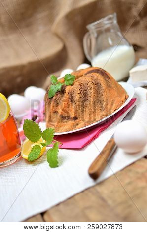 Homemade Lemon Bundt Cake With Lemon, Melissa, Milk, Eggs And Tea