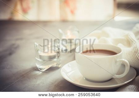 Still Life Details In Home Interior Of Living Room. Cup Of Cocoa On A Table, Candles And Knited Blan