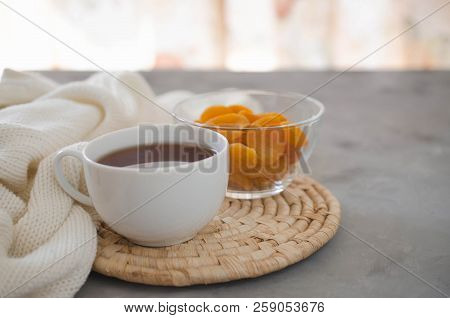 Still Life Details In Home Interior Of Living Room. Cup Of Tea And Dried Apricots On A Table, Candle