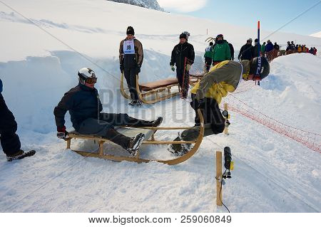 Grindelwald, Switzerland - March 07, 2009: Unidentified Men Ride Traditional Horn-sledge At 12-th An