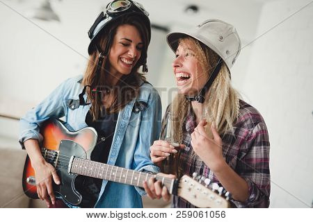 Young Happy Dancing Girls Playing Guitar And Partying