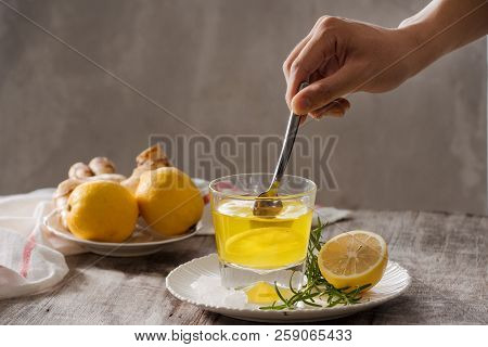 Ginger Tea With Lemon, Ginger Root And Rosemarry On Wooden Background. Small Glass Transparent Pitch