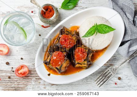 Meatballs Wrapped In Eggplant On A Plate Of Rice. Traditional Turkish Dish Islim Kebabi (kürdan Keba