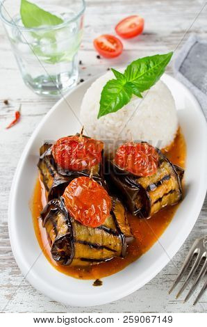 Meatballs Wrapped In Eggplant On A Plate Of Rice. Traditional Turkish Dish Islim Kebabi (kürdan Keba