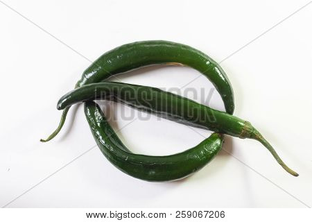 Three Chilaca Peppers Corming A Circle And Slash, Copy Space, Isolated On White, Horizontal Aspect