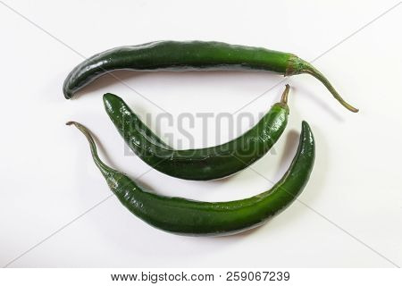 Three Chilaca Peppers, Overhead View, Isolated On White, Horizontal Aspect