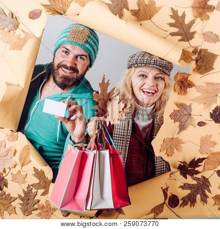 Funny Couple Are Getting Ready For Autumn Sale. Colorful Autumn And Dry Leaf. Romantic Couple Wearin