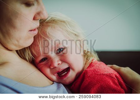 Mother Comforting Crying Little Baby, Parenting Concept