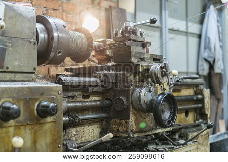 Old Machinery In A Factory From The Mid-20th C. Working Machine-tool. Old Lathe.