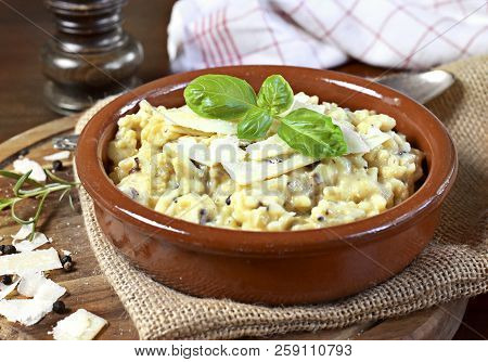 Delicious Risotto Dish In A Brown Bowl, With Mushrooms And Parmesan Cheese. Risotto A La Milanese, C