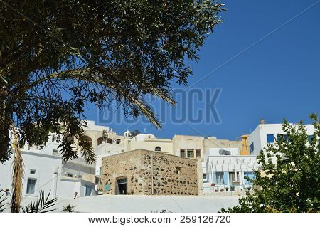 Bottom Shot Of The Houses On The Slope And The Serpentine Streets Of Pyrgos Kallistis On The Island 