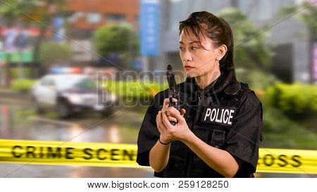 Asian American Woman Police Officer At Crime Scene
