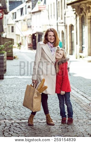 Happy Mother And Daughter At The City
