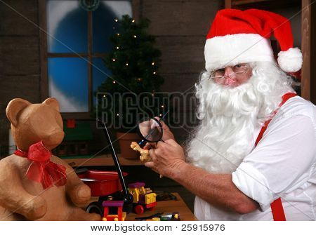 Babbo Natale dipinge un giocattolo come fa i regali di Natale per i bambini del mondo