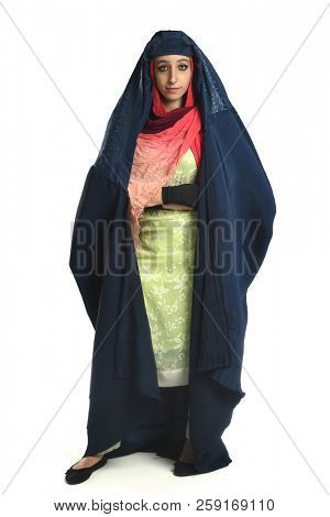 Islamic young woman wearing burqa with arms crossed isolaed over white background