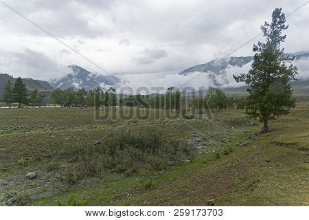Low Clouds In The Valley Of The Chuya River. August. Surroundings Of The Village Of Chibit. Altai Mo