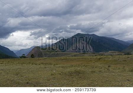Low Clouds In The Valley Of The Chuya River. August. Surroundings Of The Village Of Chibit. Altai Mo