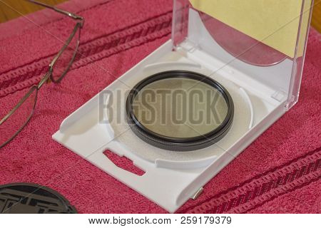 Polarizing, Cpl Filter For Lens, Lens Cap And Glasses On The Desktop