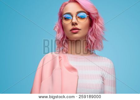 Charming Modern Hipster Woman With Pink Short Hair Wearing Pink Jacket And Glasses Looking Sensually