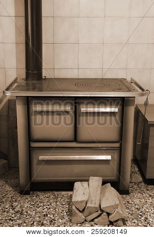 Old Wood-burning Stove Inside The Kitchen Of The Home In Mountain With Sepia Effect