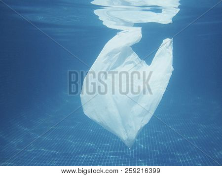 Plastic Bag Floating Into The Water. Polluted Enviromental. Recycle Garbage