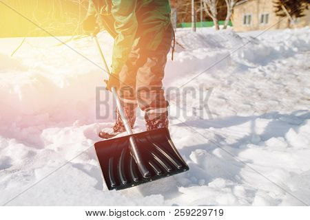 City Service Cleaning Snow Winter With Shovel After Snowstorm Yard. Sunlight