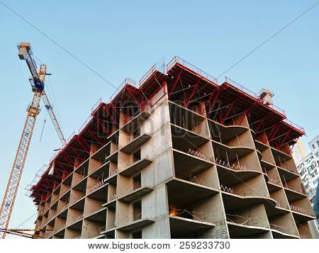 Crane And Building Construction Site. Construction Of Office Building. Crane Near Building.