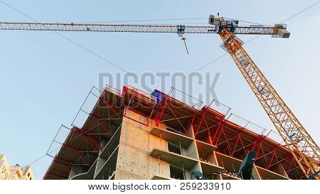 Crane. Construction Crane. Building Crane On The Background Of A Building.
