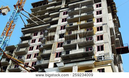 Building Under Construction. Crane Near Building. Construction Site.