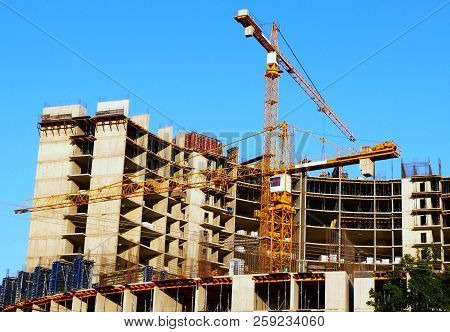 Construction Site. Two Tower Cranes Near Building. Construction Building.