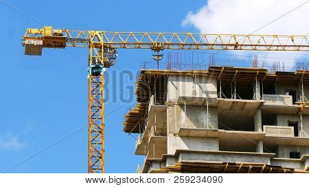 Crane. Construction Crane. Building Crane On The Background Of Building. Construction Site.