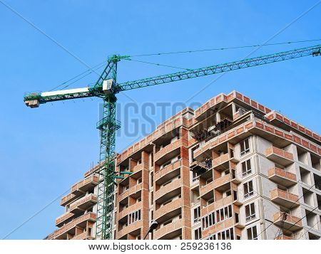 Concrete Building Under Construction. Crane Near Building. Construction Site