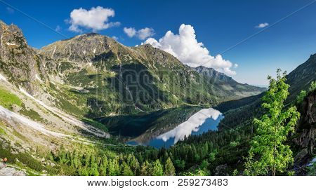 Landscape of High Tatras in the spring. Snowy mountain tops and beautiful sky. Mountain Rysy, Morskie Oko