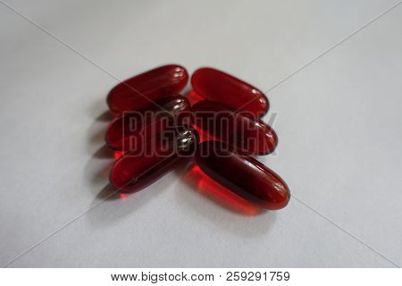Half Of Dozen Red Capsules Of Krill Oil