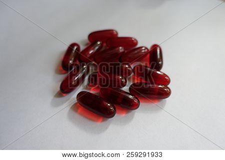 Heap Of Red Softgel Capsules Of Krill Oil