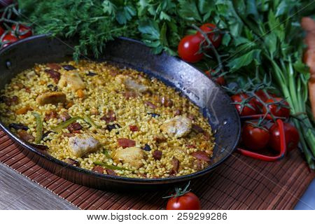 Fried Rice With Chicken. Prepared And Served In A Wok. Natural Wood In The Background. Top View.