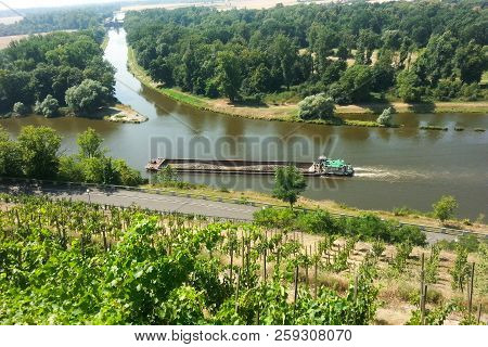 The Mělník Town - Confluence Rivers Vltava And Elbe And A Cargo Ship Carrying The Material.the River