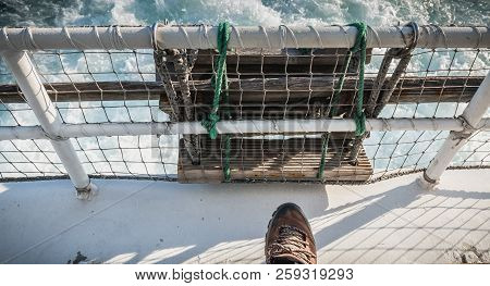 relaxed man sitting at the back of a ferry leaving the port towards Yeu Island