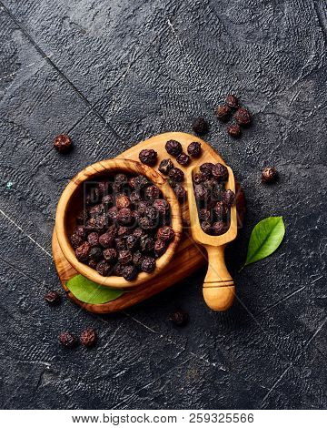 Dried Hawthorn Fruits On Black Background. Top View Of Crataegi Fructus.