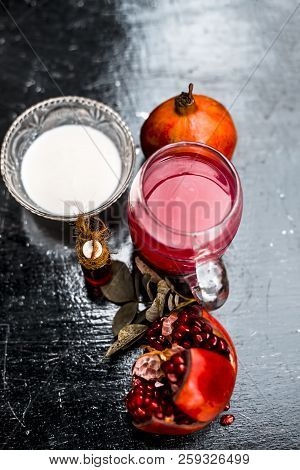 Close Up Of Pomegranate Shrbat Or Juice With Milk,pomegranate Essence,sugar And Raw Pomegranate On W