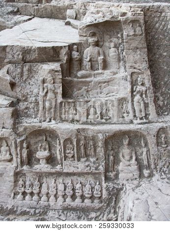 Famous Longmen Grottoes (statues of Buddha and Bodhisattvas carved in the monolith rock near Luoyang in Hennn province, China)