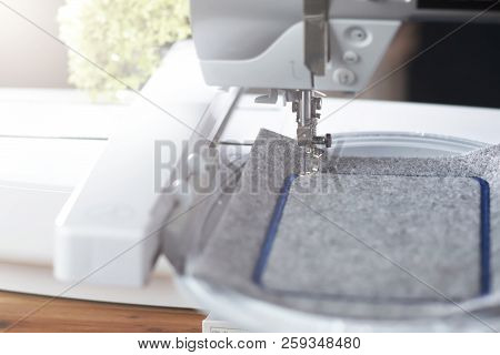 Detail View On A Modern Computerised Sewing Machine With Embroidery Unit In Bright Light Stitching A