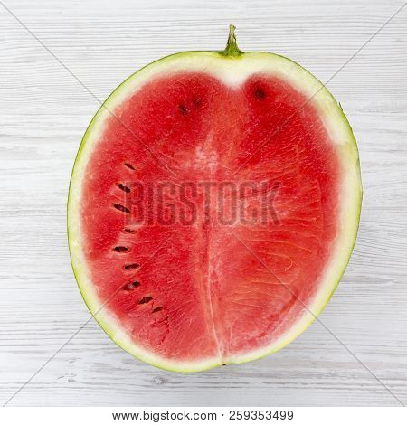 Half Cutted Watermelon On White Wooden Table. Close-up.