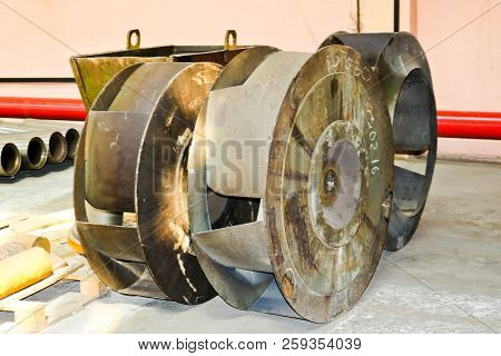 A Large Iron Metal Round Wheel With Louvers To Pump Water Into The Pump. Spare Part Of The Transfer 