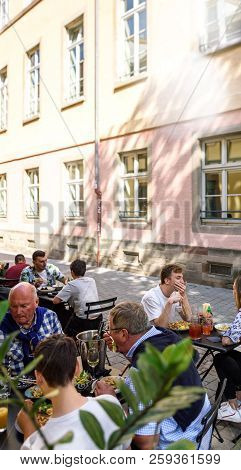 Strasbourg, France - Sep 15, 2018: Group Of Happy Customers Enjoying Food On Place Des Orphelins Cen