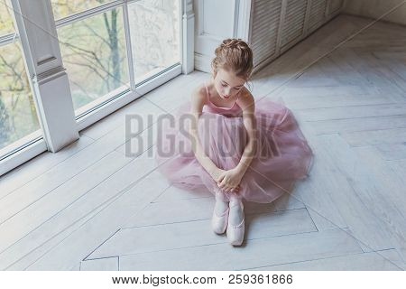 Young Classical Ballet Dancer Girl In Dance Class. Beautiful Graceful Ballerina Practice Ballet Posi