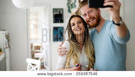 Pretty Loving Couple Is Making Selfie Indoor